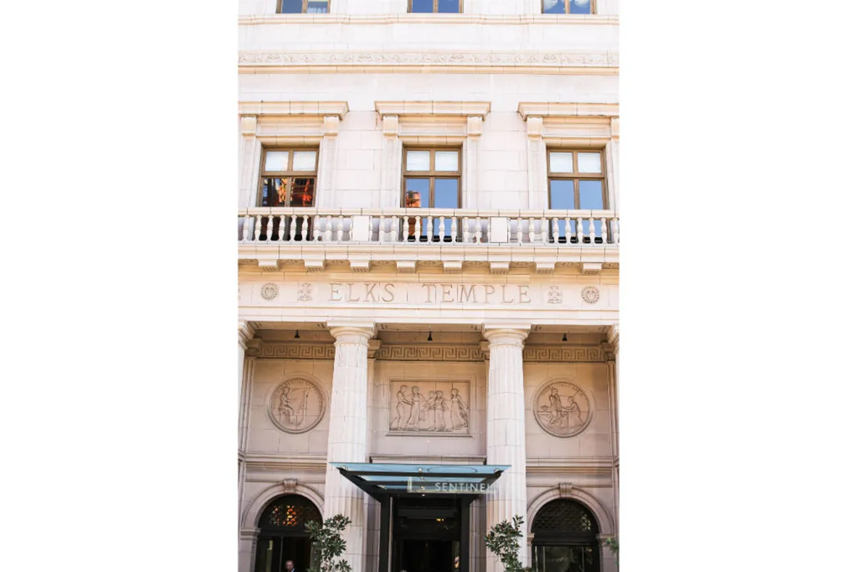 An exterior perspective of the Elks Temple, with ornate columns, detailed reliefs, and classic signage. The building’s historic character and welcoming ambiance suggest ties to Portland’s storied cultural scene.